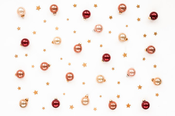 Christmas pastel, red, pearl bells, golden stars on white background, top view, flat lay
