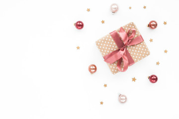 Fototapeta na wymiar Christmas pastel, red, pearl bells, golden stars, christmas gift on white background, top view, flat lay