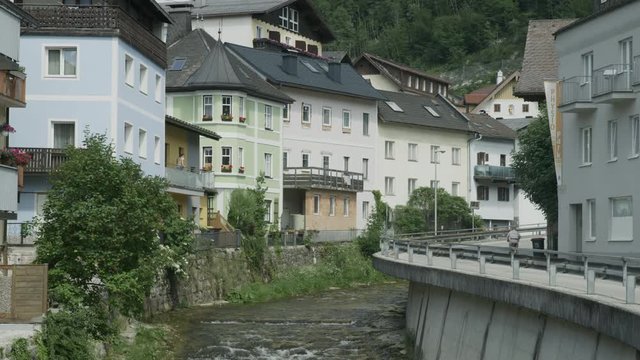 Wide shot of river flowing in city / Ebensee, Austria