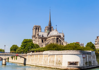 Fototapeta na wymiar Notre Dame de Paris Catholic Christian Cathedral with the Seine river and the bridge Archbishopric on a sunny spring day. Paris