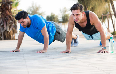 Portrait of sportsmen who are pushing-up