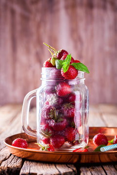 Fresh Strawberries in a glass Jar for Drinks on Vintage wooden background.Food or Healthy diet concept.Vegetarian.Copy space for text. selective focus