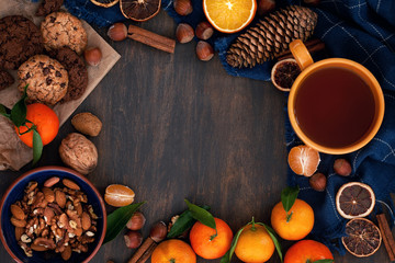 Winter comfort food - chocolate cookies, nuts, tangerines and tea