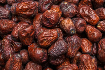 Close up raw organic medjool dates ready to eat. Background of date palm texture.