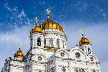 Golden domes of the Cathedral of Christ the Savior in Moscow against blue sky