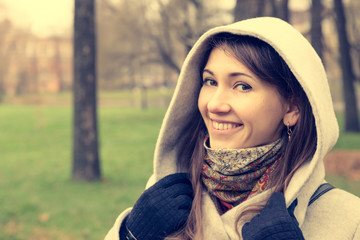 Beautiful smiling girl in a coat. Toned