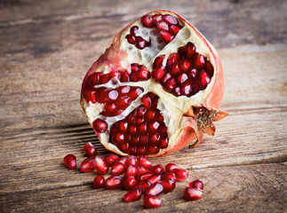 ripe pomegranate on wooden background
