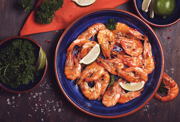 Prawns on the large blue plate with lime and parsley