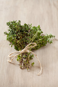 Bunch of fresh organic thyme on a wooden background
