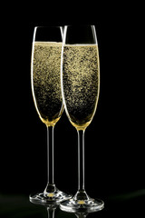 Champagne glasses on black background