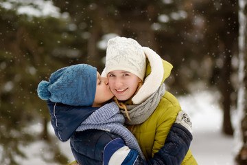 Boy and girl playing in winter