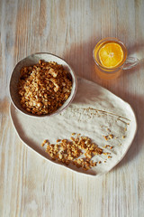 Healthy Breakfast of Champions. Muesli , a glass of water with a slice of orange. Ceramic handmade