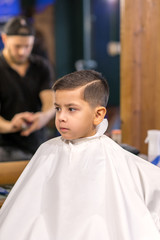 the boy is cut in hairdressing salon