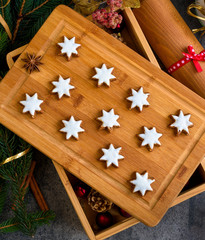 Fototapeta premium Christmas gingerbread with decoration on a wooden board. Top view.