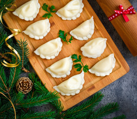 Christmas dumplings with decoration on a grey board. Top view.