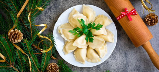 Christmas dumplings with decoration on a grey board. Top view.