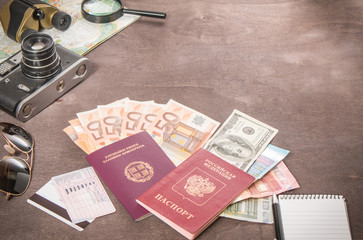Holiday and Traveler's accessories, Passports and banknotes. Travel concept on wooden background. Preparation and planning of holidays.