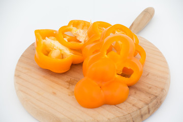 Freshness composition with orange bell pepper on cutting board isolated top view