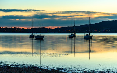 Daybreak waterscape over the bay with boats