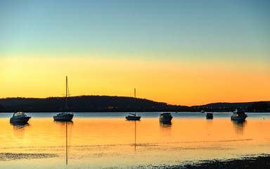 Daybreak waterscape over the bay with boats