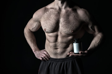 Athletic bodybuilder isolated on black background.