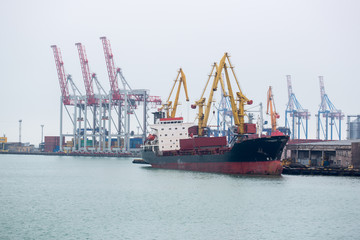 Vessel dry cargo on loading, unloading in port. Bulker in port. port terminal