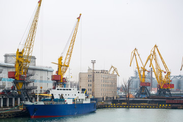 Fototapeta na wymiar Vessel dry cargo on loading, unloading in port. Bulker in port. port terminal