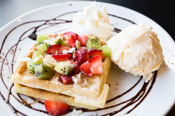 Waffles with fresh berries, whipped cream and ice cream