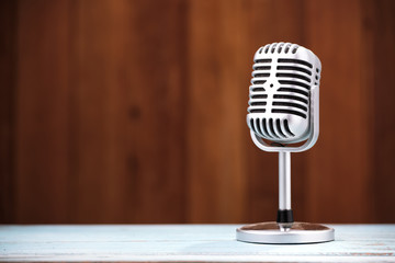 Retro microphone on wooden table