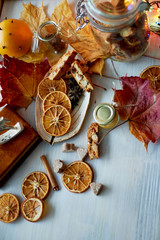 Cookies, biscotti, slices of orange, autumn leaves and a jar of jam or . The atmosphere of warmth and coziness.