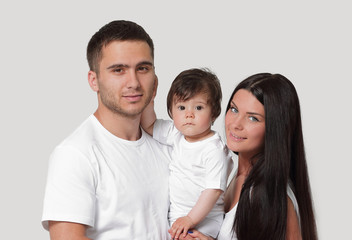 Happy family with newborn baby on a white background.