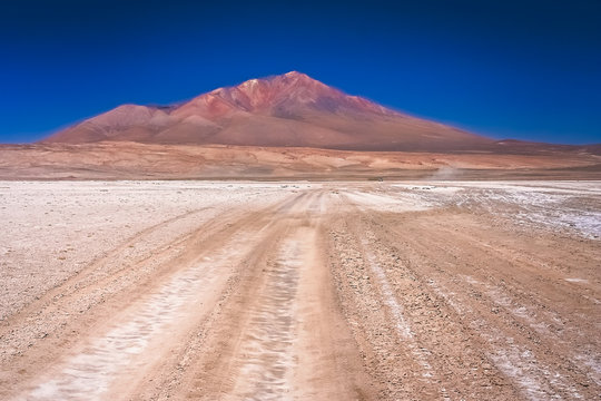 Sandy and gravel desert road through Altiplano