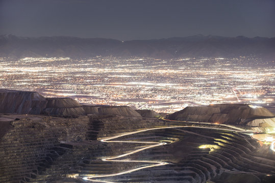 High angle view of Bingham Canyon against illuminated cityscape