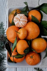 On the table are Christmas mandarins. The New Year is coming