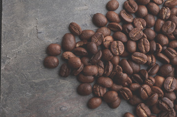 Coffee beans on stone background. Top view with copy space for your text