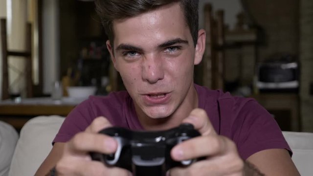 Excited intense player pushing buttons on joystick feeling disappointed after his loss