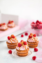 Raspberry and caramel cupcakes on white background