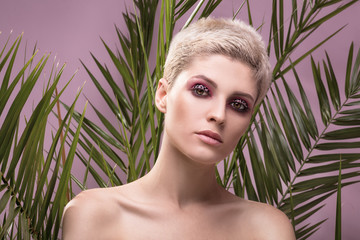 Fototapeta premium Portrait of blonde girl with artistic makeup.