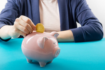 Piggy bank, hand holds golden bitcoin coin virtual money. Cryptocurrency and saving concept