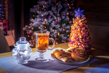 New Year. Christmas tree. treats on the table on the background of the New Year tree.