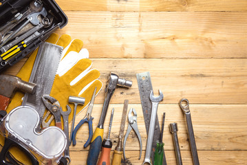 Assorted work tools on wooden board - DIY concept