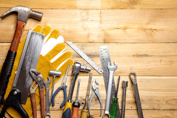 Assorted work tools on wooden board - DIY concept