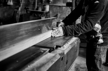 Falegname mentre lavora il legno nella sua fabbrica