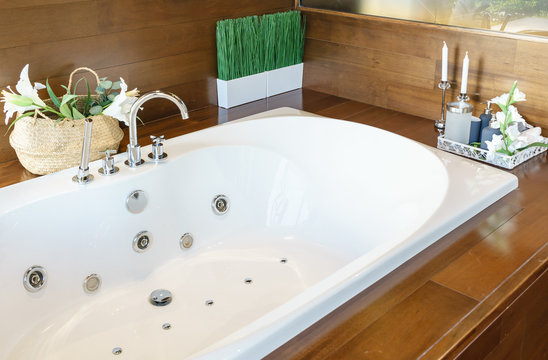 Bathroom interior in cozy colors with modern bathtub