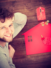 Smiling man with property symbols.