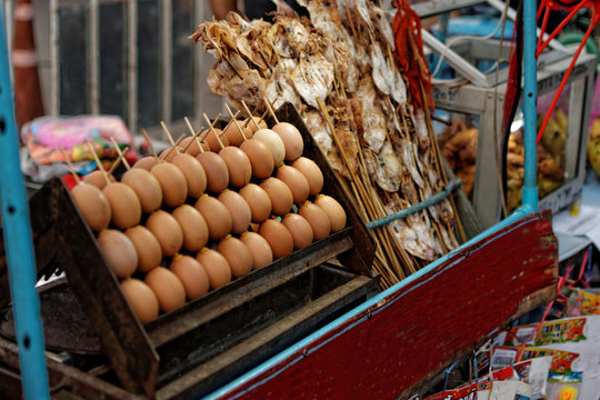 Roasted Egg and Grilled squid : Food from temple fair : The local food from the northern of Thailand.