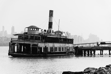 The ferryboat Binghamton, a workhorse that served on the Hudson River for more than a century. Manhatan in the background - obrazy, fototapety, plakaty