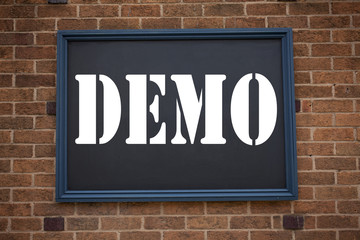 Fototapeta premium Conceptual hand writing text caption inspiration showing announcement Demo. Business concept for Software Demonstration written on frame old brick background with copy space