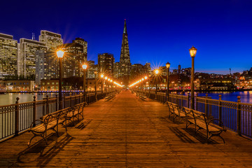 Downtown San Francisco and the Transamerica Pyramid at Christmas from wooden Pier 7 at sunset