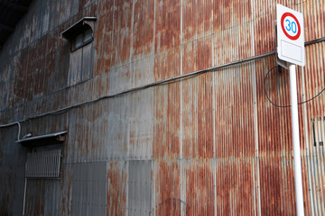zinc house wall with rust in the city at Kyoto. Rusty zinc home wall in Japan.
